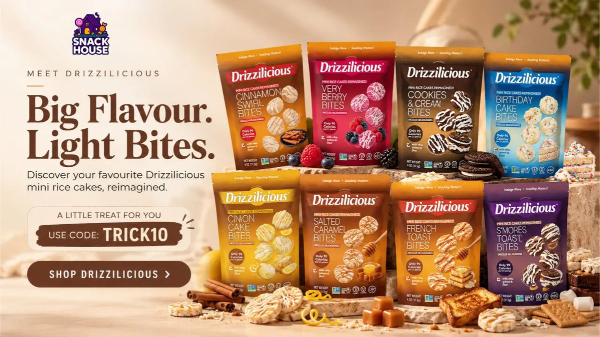A promotional product display for Drizzlicious mini rice cakes in multiple flavor packs, arranged on a styled tabletop with cookies, nuts, and candies. The image includes marketing text on the left and the snack packs as the main sellable products.
